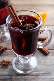 Delicious red mulled wine on wooden table, closeup Photo of Delicious red mulled wine on wooden table, closeup