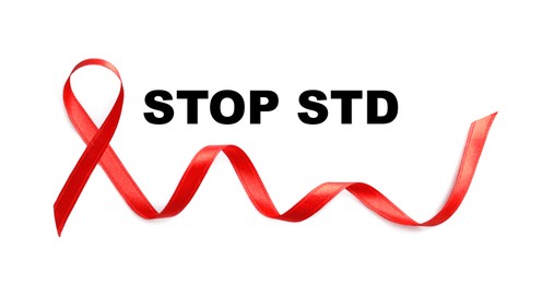 Red awareness ribbon and text Stop STD on white background, top view Image of Red awareness ribbon and text Stop STD on white background, top view