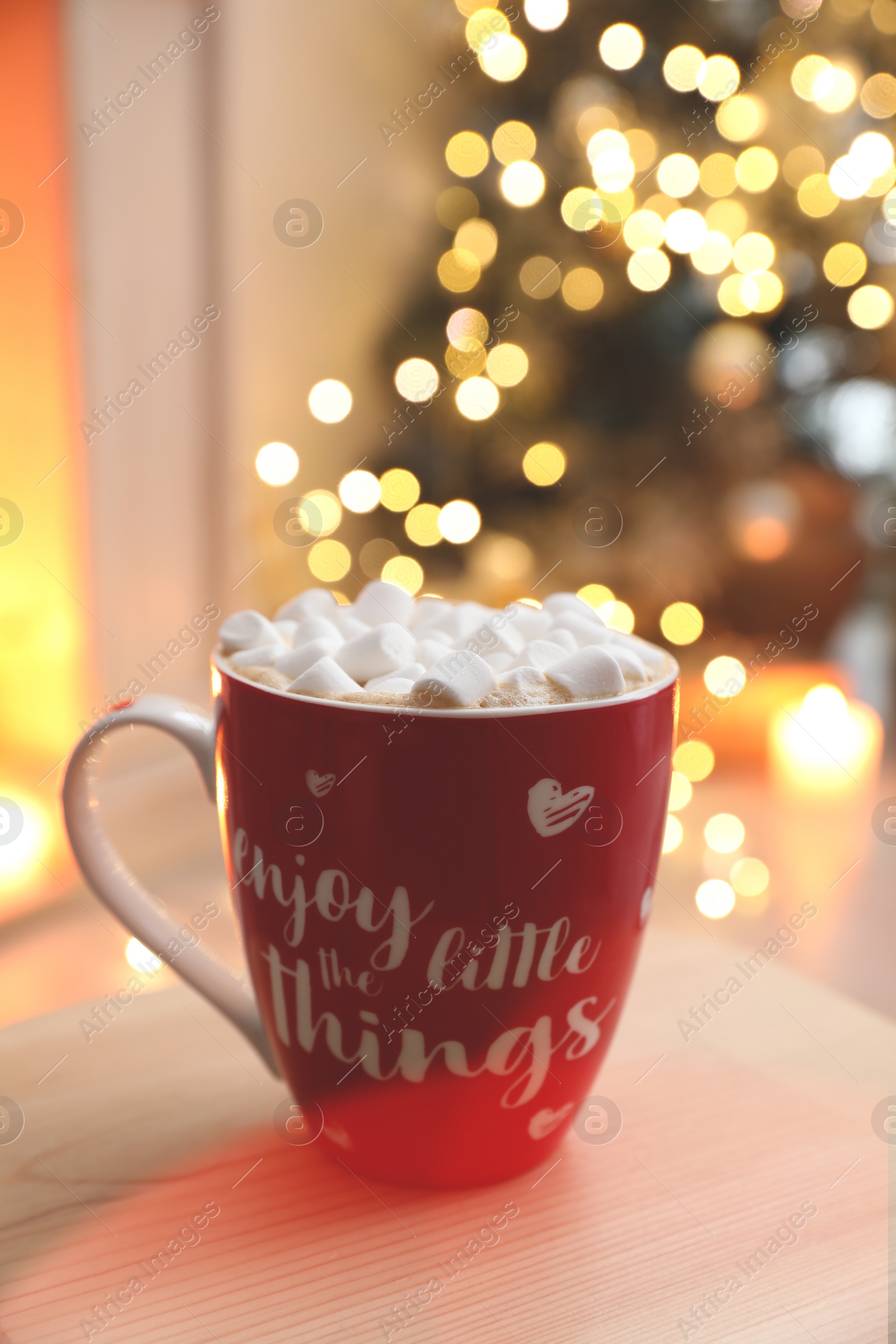 Hot drink with marshmallows in room. Magic Christmas atmosphere Photo of Hot drink with marshmallows in room. Magic Christmas atmosphere