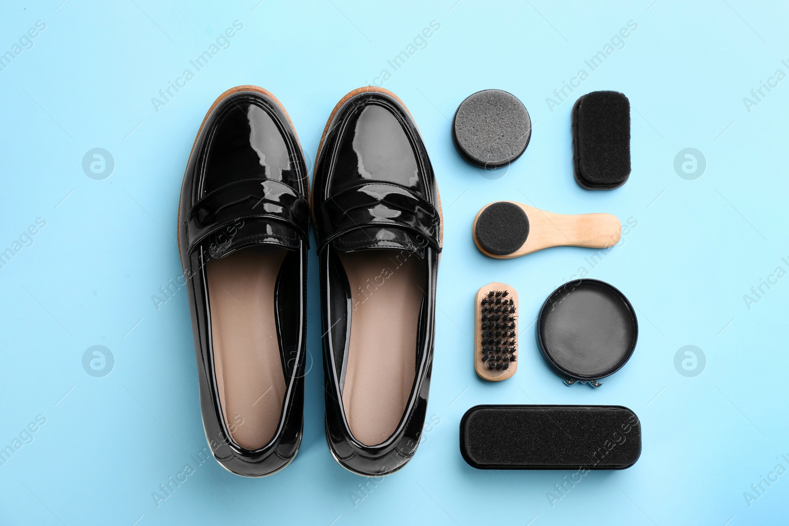 Flat lay composition with shoe care accessories and footwear on light blue background Photo of Flat lay composition with shoe care accessories and footwear on light blue background