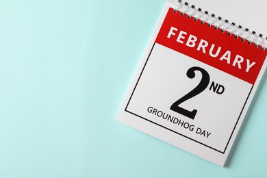 Top view of calendar with date February 2nd on light blue background, space for text. Groundhog day Photo of Top view of calendar with date February 2nd on light blue background, space for text. Groundhog day