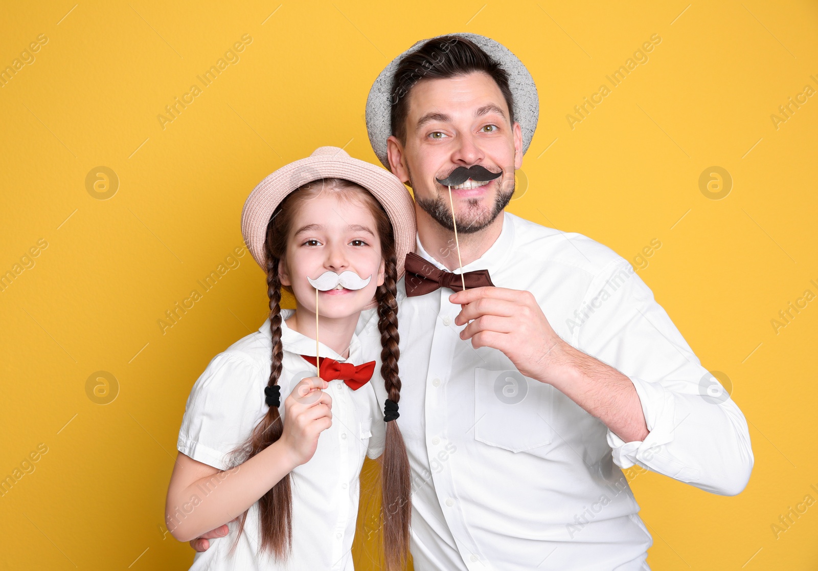 Dad and his daughter having fun on color background. Father's day celebration Photo of Dad and his daughter having fun on color background. Father's day celebration