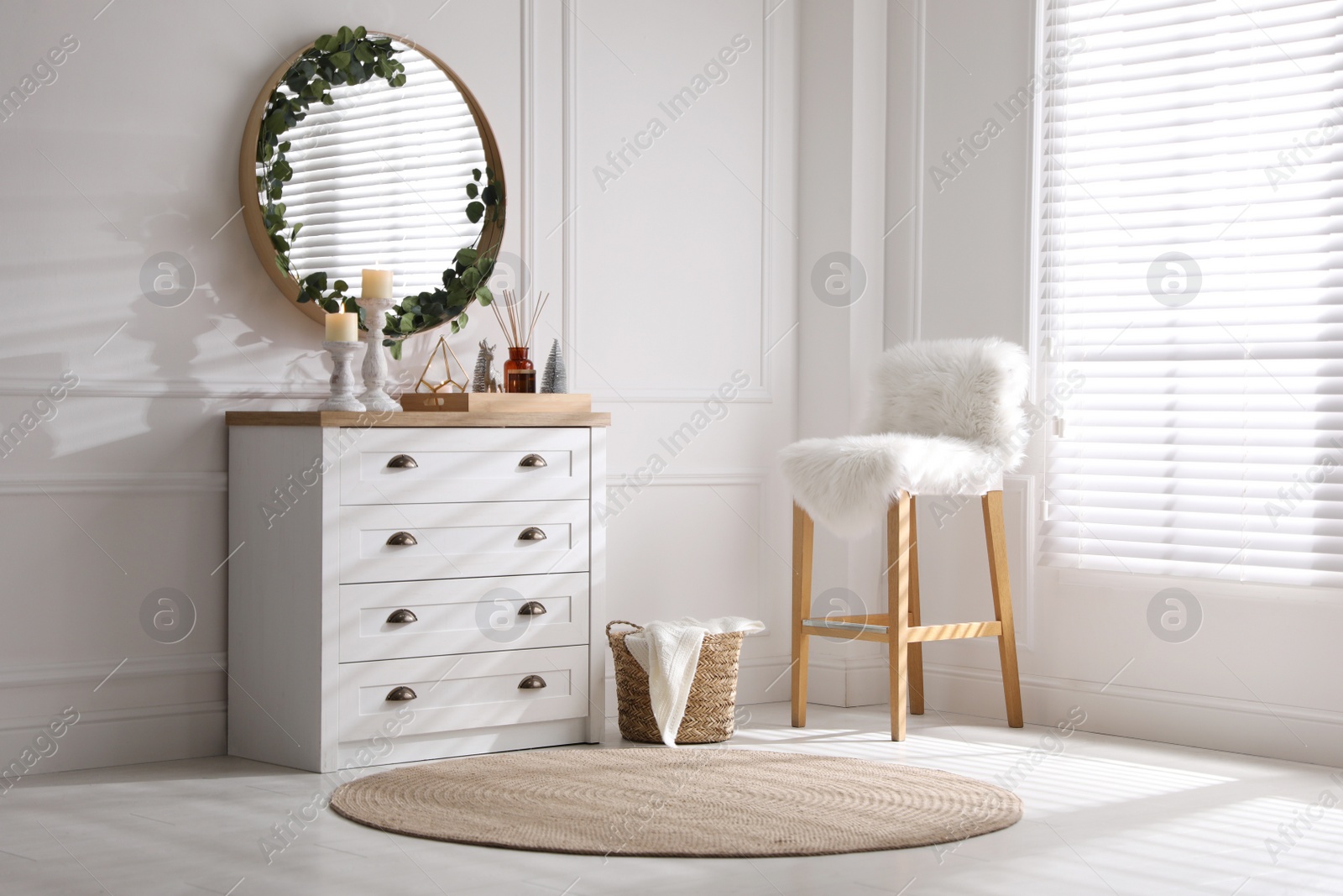 Modern room interior with chest of drawers and mirror on white wall Photo of Modern room interior with chest of drawers and mirror on white wall