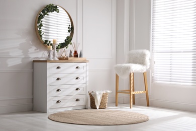 Modern room interior with chest of drawers and mirror on white wall Photo of Modern room interior with chest of drawers and mirror on white wall
