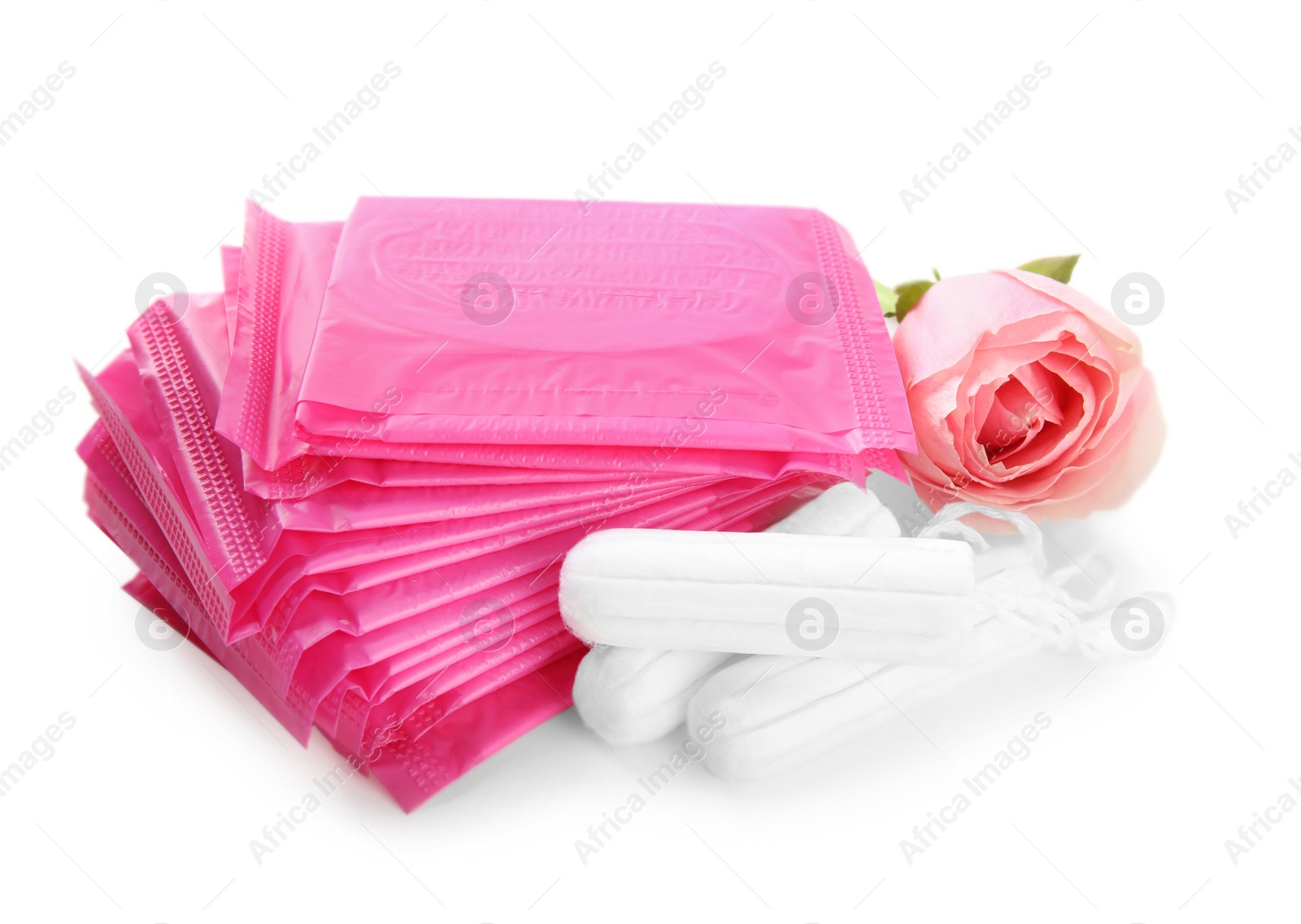 Tampons, disposable menstrual pads and beautiful rose on white background Photo of Tampons, disposable menstrual pads and beautiful rose on white background