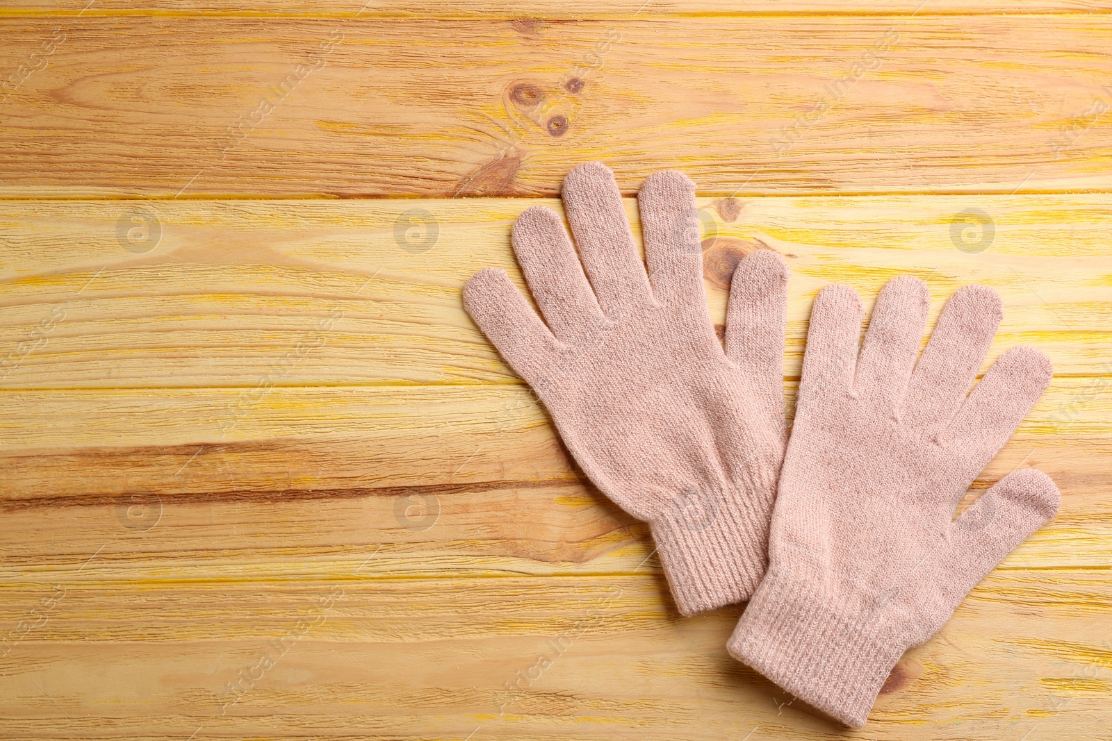 Photo of Stylish pink gloves on wooden background, flat lay. Space for text