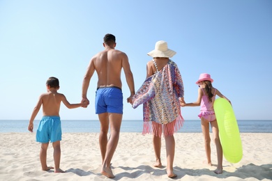 Family at beach on sunny summer day Photo of Family at beach on sunny summer day
