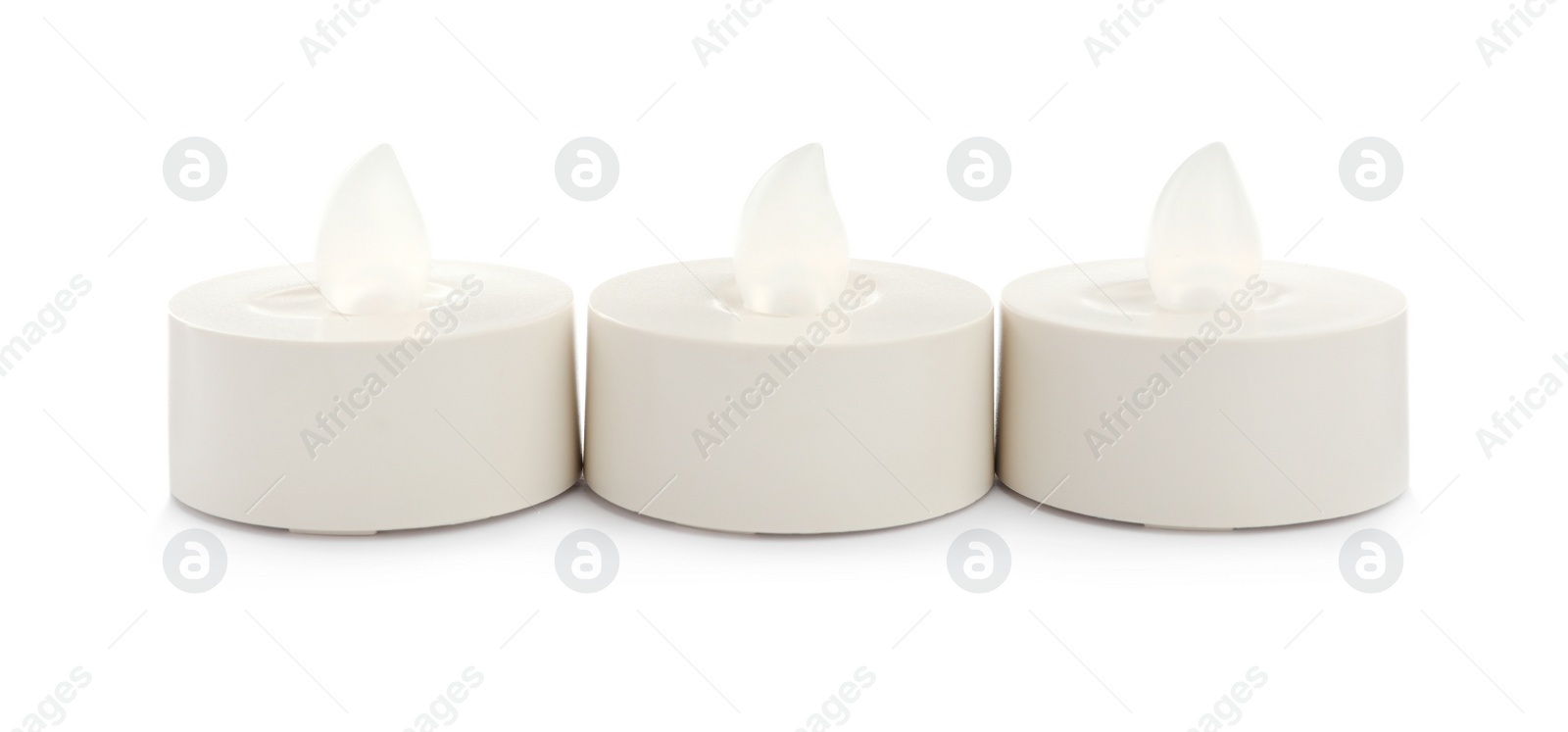 Decorative flameless LED candles on white background Photo of Decorative flameless LED candles on white background