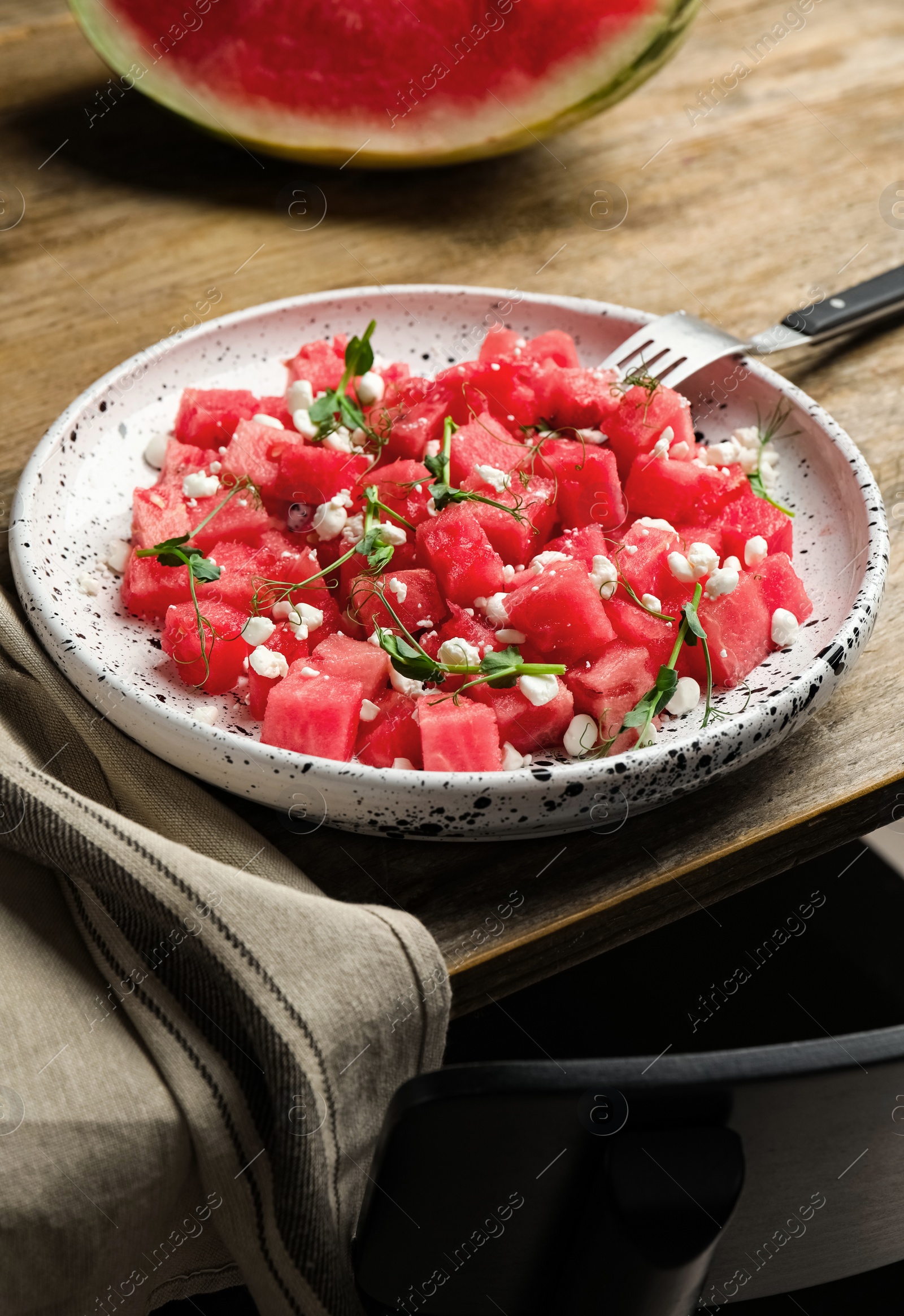 Delicious salad with watermelon served on wooden table Photo of Delicious salad with watermelon served on wooden table