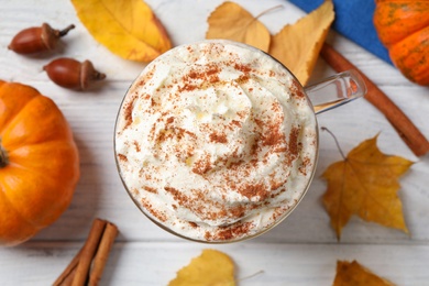 Delicious pumpkin latte on white table, top view Photo of Delicious pumpkin latte on white table, top view