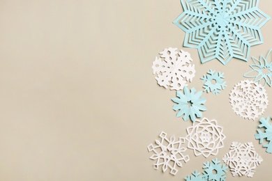 Many paper snowflakes on light grey background, flat lay. Space for text Photo of Many paper snowflakes on light grey background, flat lay. Space for text