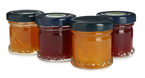 Jars with different jams on white background Photo of Jars with different jams on white background