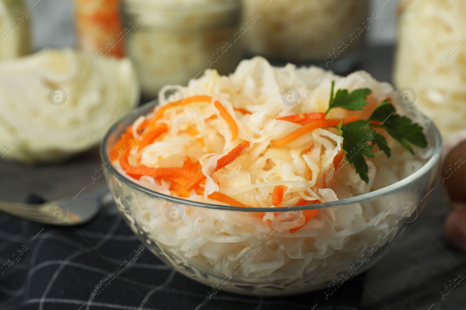 Tasty fermented cabbage with carrot on table, closeup Photo of Tasty fermented cabbage with carrot on table, closeup