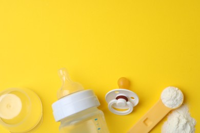 Flat lay composition with powdered infant formula on yellow background, space for text. Baby milk Photo of Flat lay composition with powdered infant formula on yellow background, space for text. Baby milk