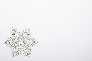 Beautiful decorative snowflake on white background, top view. Space for text Photo of Beautiful decorative snowflake on white background, top view. Space for text