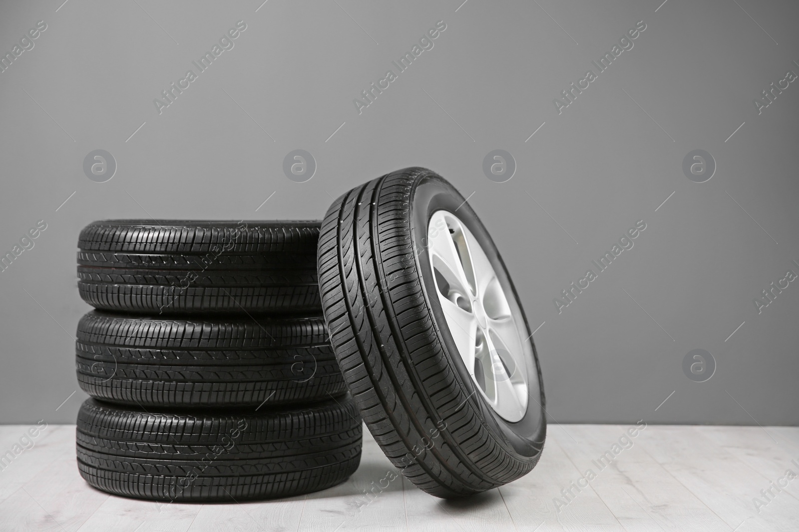 Car tires near gray wall Photo of Car tires near gray wall