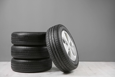 Car tires near gray wall Photo of Car tires near gray wall