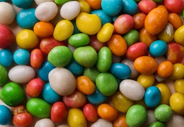 Many delicious colorful dragee candies as background, top view Photo of Many delicious colorful dragee candies as background, top view