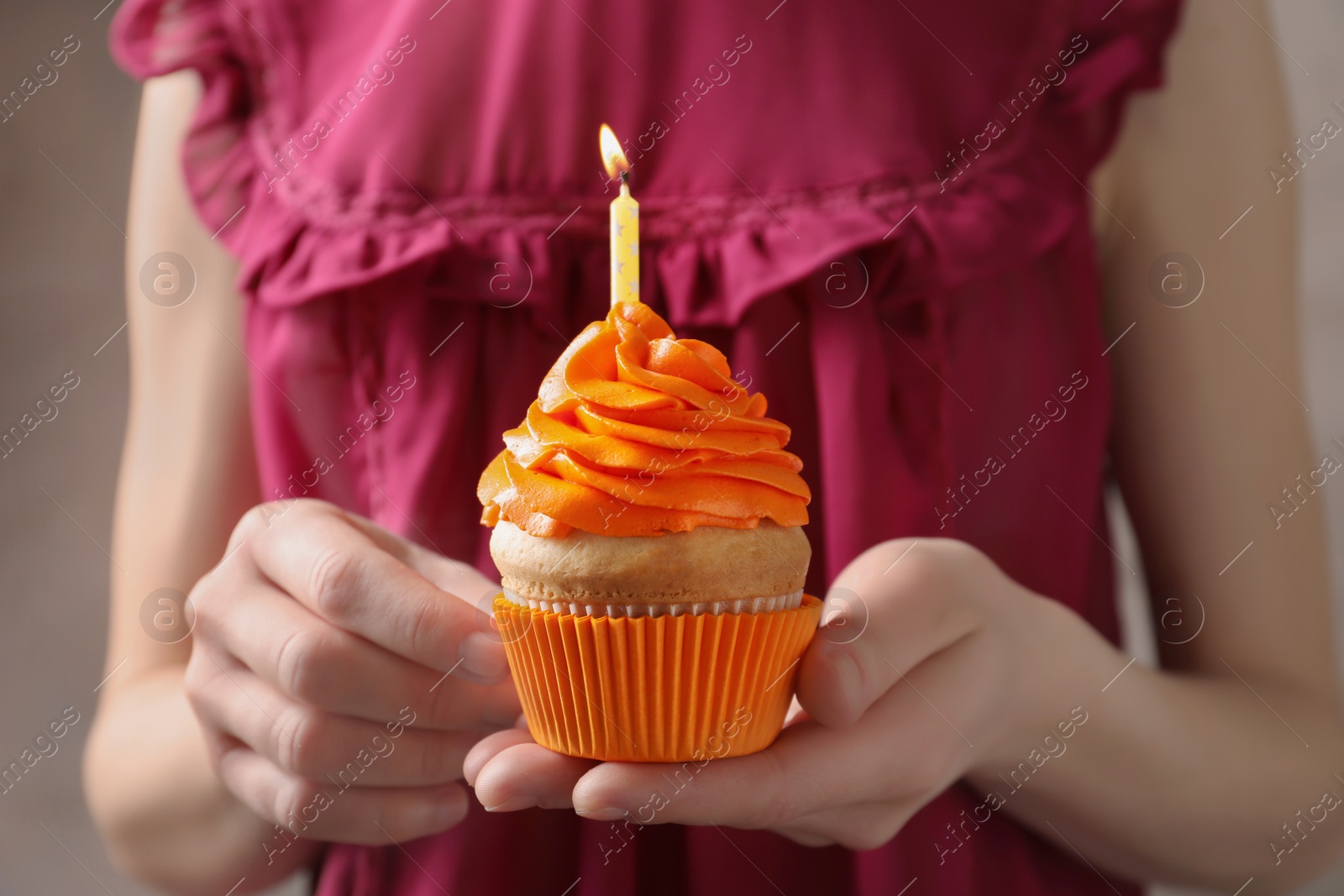 Woman holding birthday cupcake, closeup Photo of Woman holding birthday cupcake, closeup