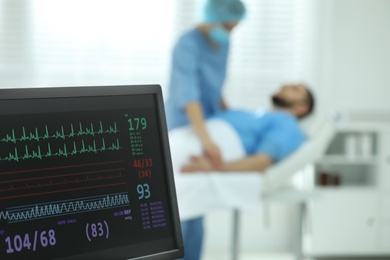 Monitor with cardiogram in hospital, focus on screen. Space for text Photo of Monitor with cardiogram in hospital, focus on screen. Space for text