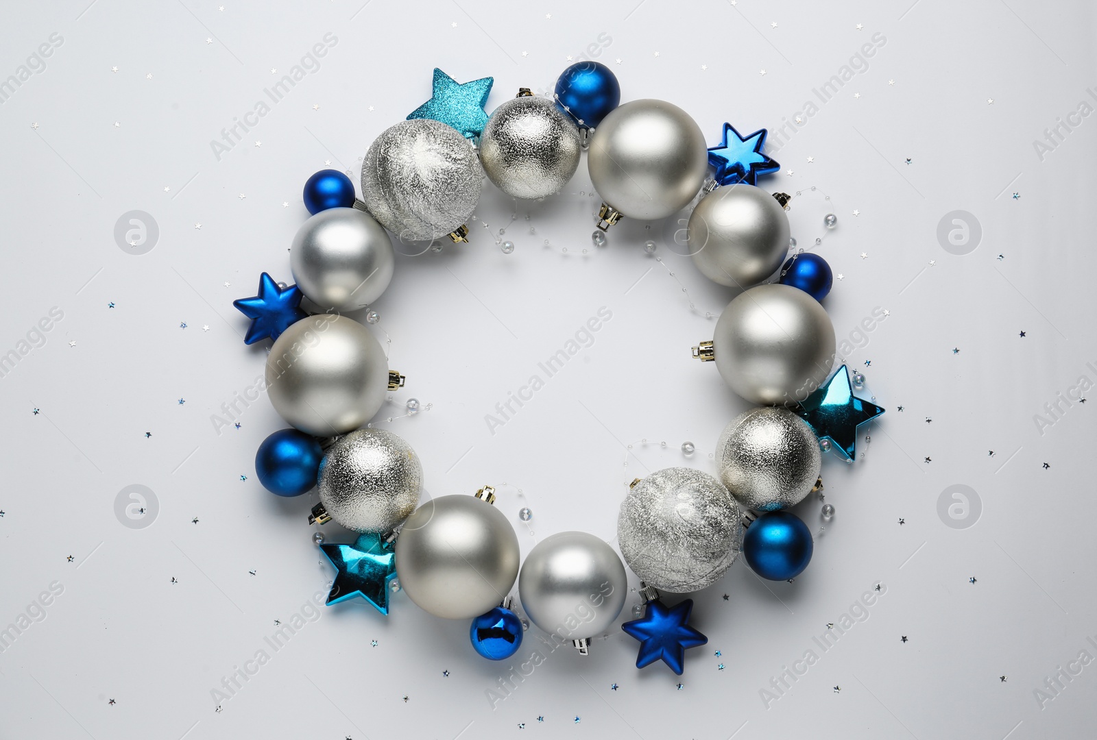 Beautiful festive wreath made of different Christmas balls on white background, top view Photo of Beautiful festive wreath made of different Christmas balls on white background, top view
