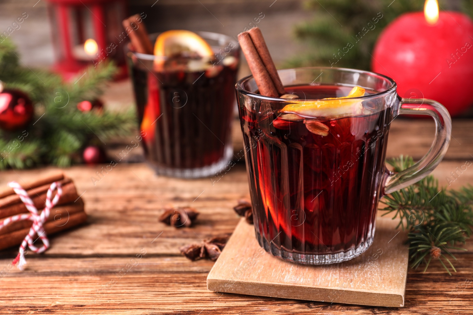 Aromatic mulled wine on wooden table, space for text Photo of Aromatic mulled wine on wooden table, space for text