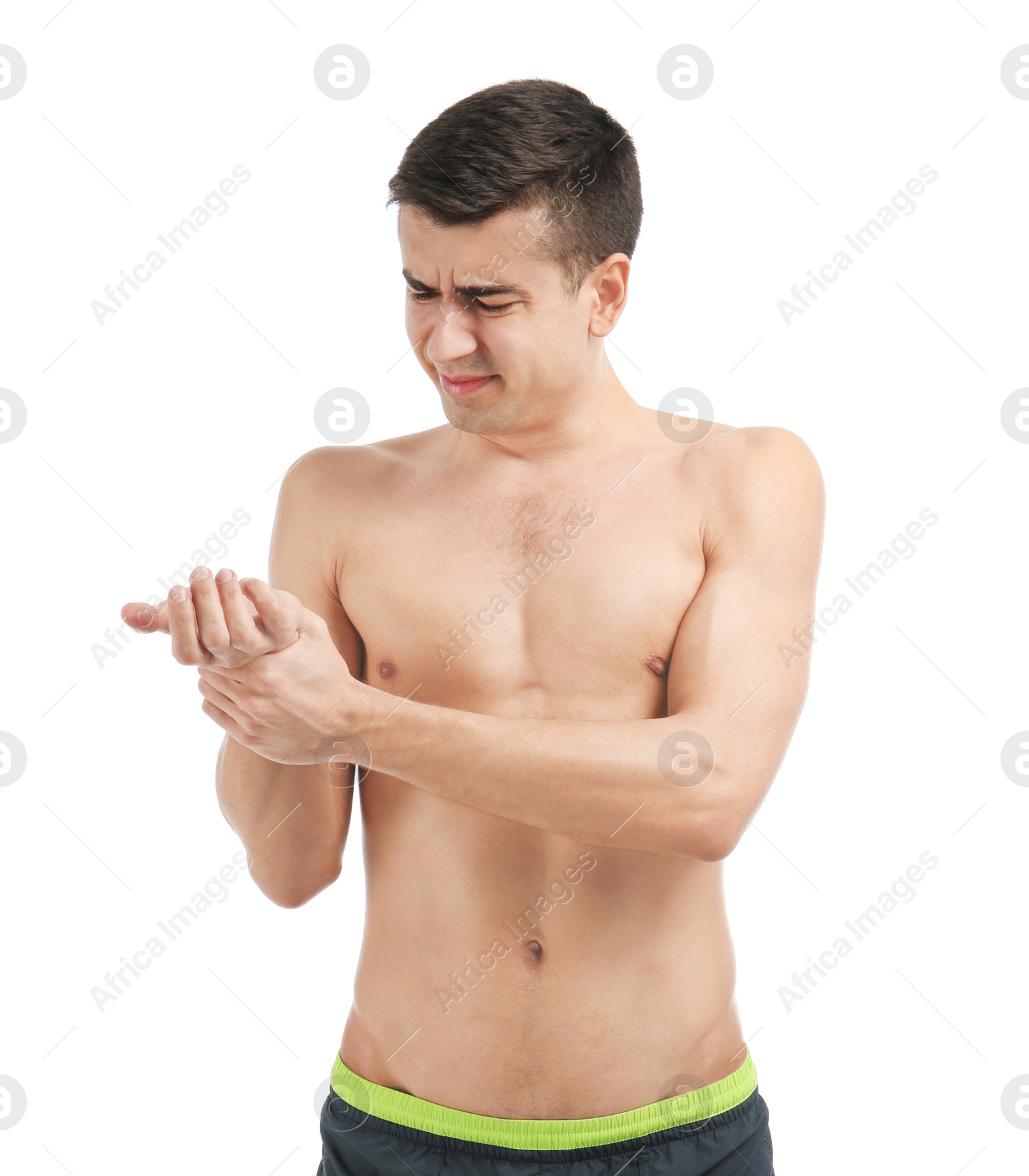 Young man suffering from pain in wrist on white background Photo of Young man suffering from pain in wrist on white background