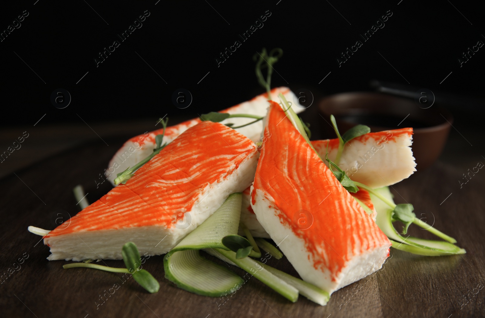 Fresh crab sticks with cucumber and soy sauce on serving board, closeup Photo of Fresh crab sticks with cucumber and soy sauce on serving board, closeup