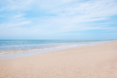 Photo of Beautiful view of sandy beach and sea on sunny day