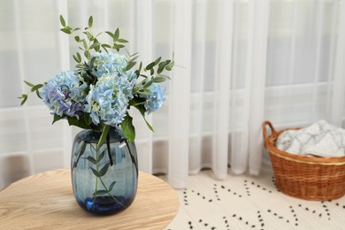 Beautiful blue hortensia flowers in vase on table indoors. Space for text Photo of Beautiful blue hortensia flowers in vase on table indoors. Space for text
