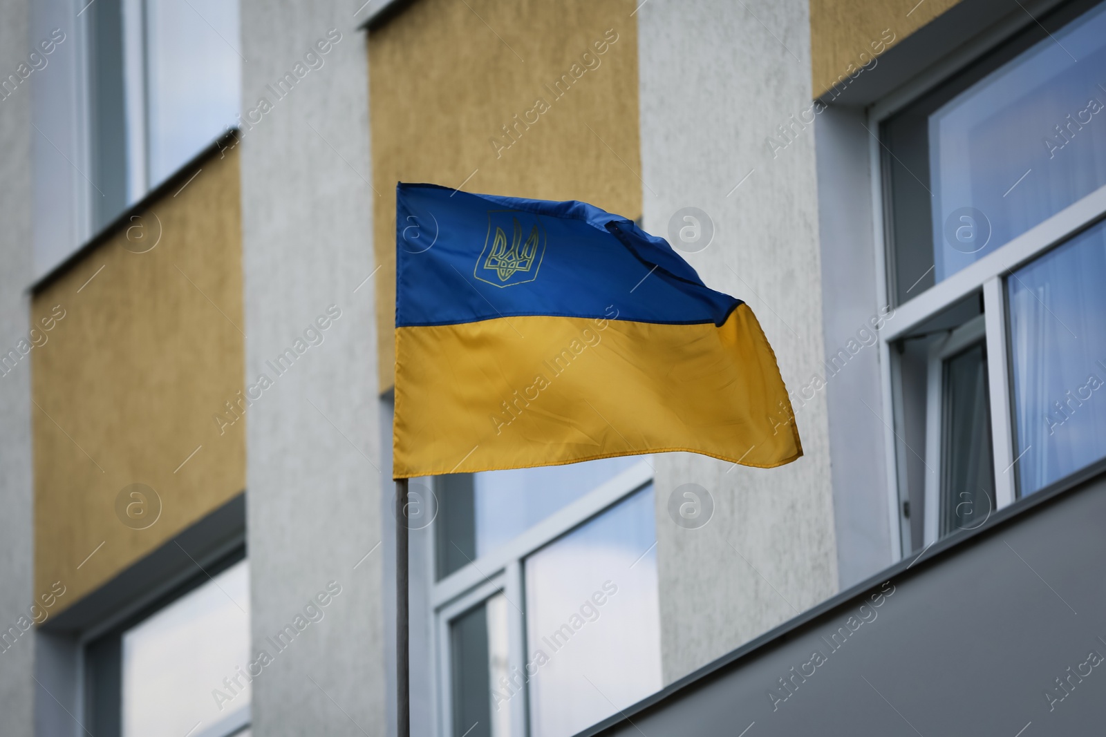 National flag of Ukraine on building facade Photo of National flag of Ukraine on building facade