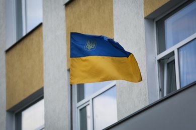 National flag of Ukraine on building facade Photo of National flag of Ukraine on building facade