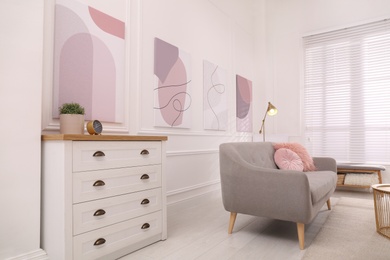 Stylish living room interior with comfortable sofa and beautiful pictures Photo of Stylish living room interior with comfortable sofa and beautiful pictures