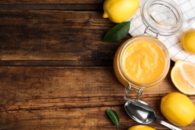 Delicious lemon curd and fresh fruits on wooden table, flat lay. Space for text Photo of Delicious lemon curd and fresh fruits on wooden table, flat lay. Space for text