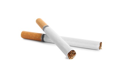 Cigarettes with orange filters isolated on white Photo of Cigarettes with orange filters isolated on white