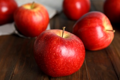 Ripe red apples on wooden table, closeup Photo of Ripe red apples on wooden table, closeup