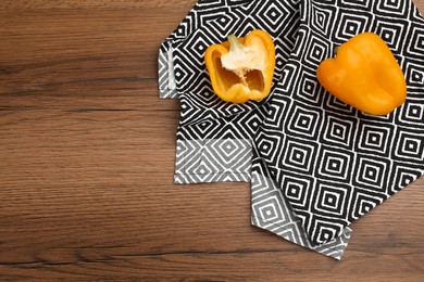 Kitchen towel and bell peppers on wooden table, flat lay. Space for text Photo of Kitchen towel and bell peppers on wooden table, flat lay. Space for text