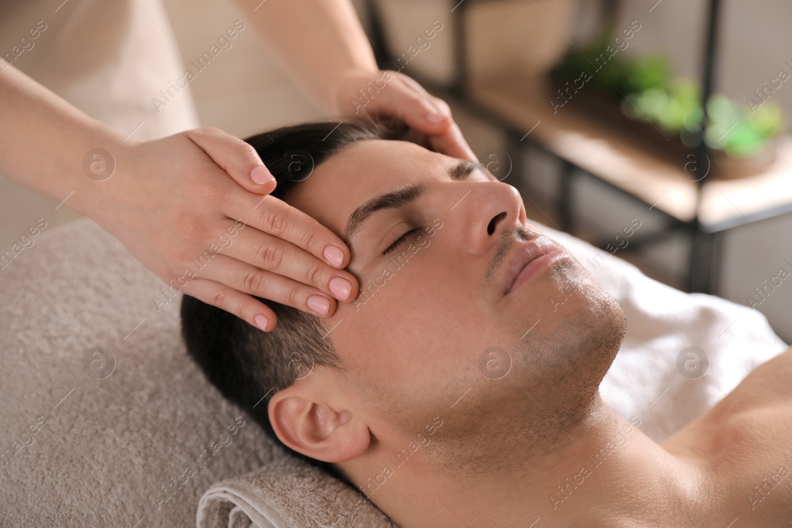 Man receiving facial massage in beauty salon, closeup Photo of Man receiving facial massage in beauty salon, closeup