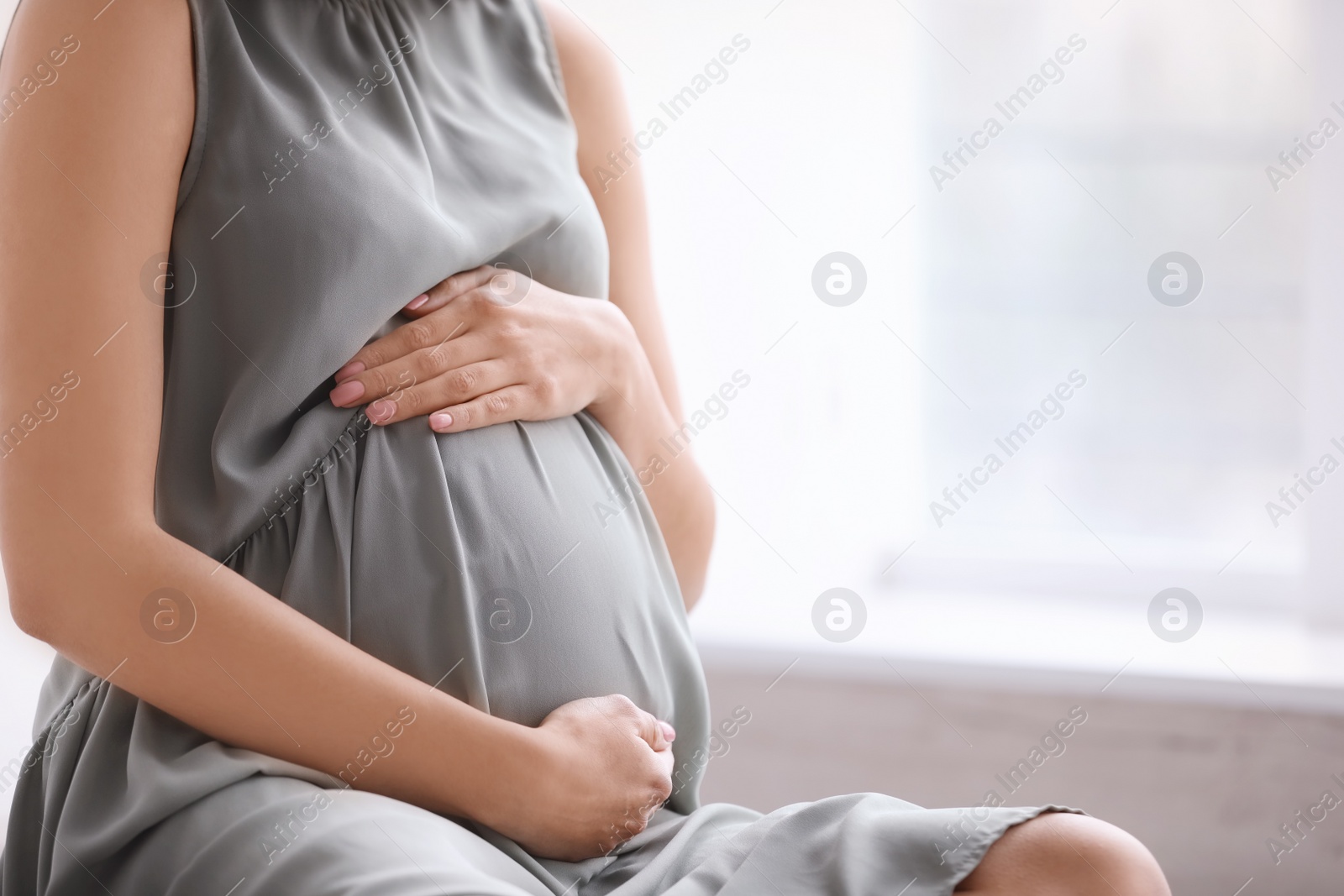 Young pregnant woman at home, closeup Photo of Young pregnant woman at home, closeup