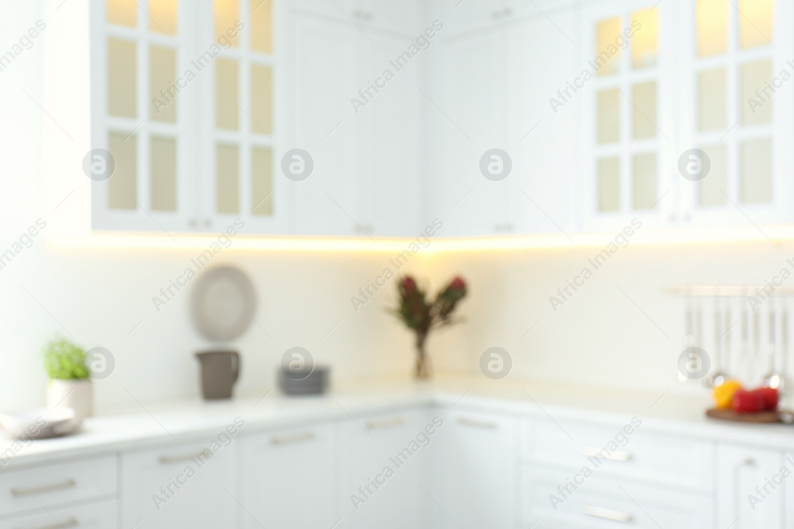 Blurred view of modern kitchen interior with white furniture Photo of Blurred view of modern kitchen interior with white furniture