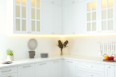 Blurred view of modern kitchen interior with white furniture Photo of Blurred view of modern kitchen interior with white furniture