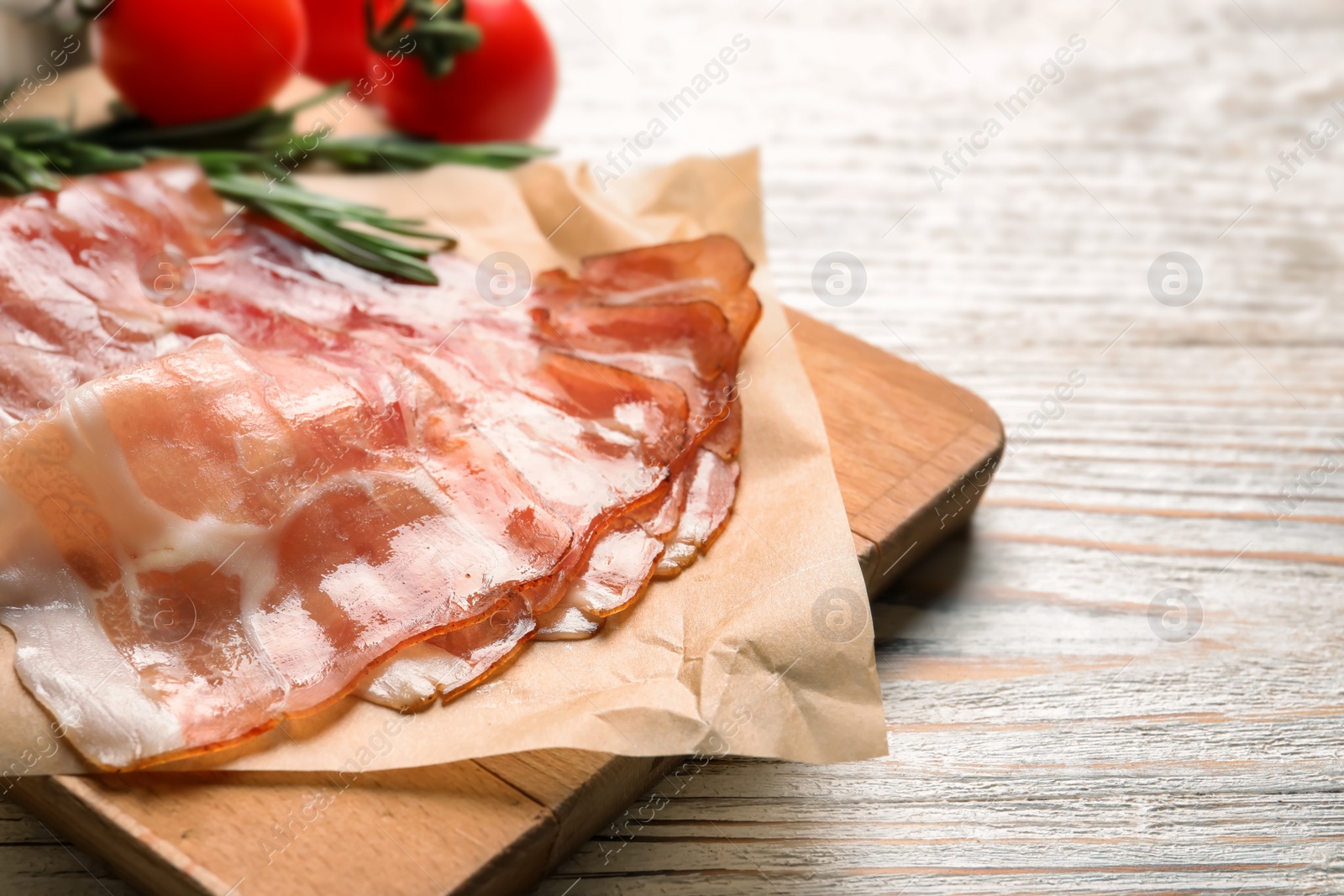 Board with raw bacon rashers on wooden background Photo of Board with raw bacon rashers on wooden background