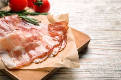 Board with raw bacon rashers on wooden background Photo of Board with raw bacon rashers on wooden background