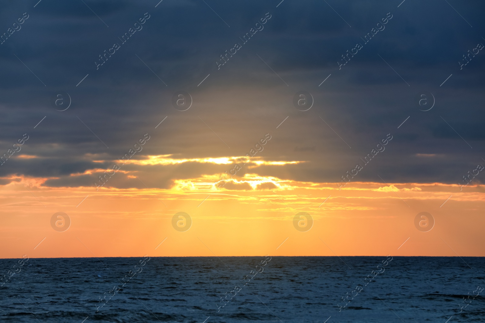 Picturesque view of beautiful sky with clouds over sea at sunset Photo of Picturesque view of beautiful sky with clouds over sea at sunset