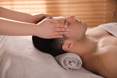 Man receiving facial massage in beauty salon Photo of Man receiving facial massage in beauty salon