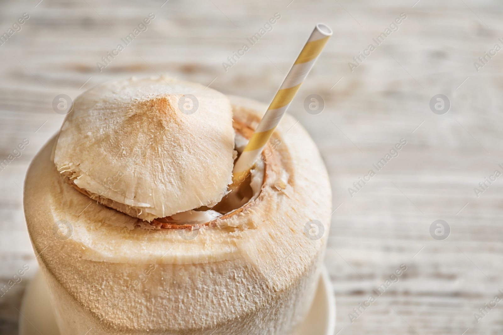 Fresh coconut drink in nut on wooden background Photo of Fresh coconut drink in nut on wooden background
