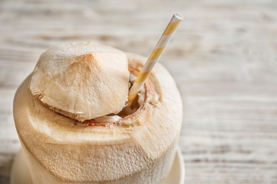 Fresh coconut drink in nut on wooden background Photo of Fresh coconut drink in nut on wooden background