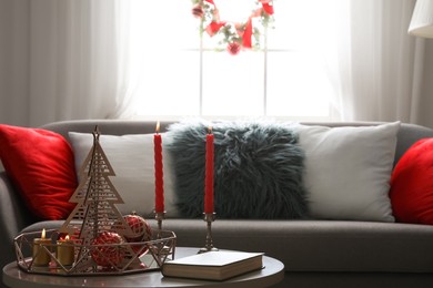 Christmas decor with candles on table in living room. Festive interior Image of Christmas decor with candles on table in living room. Festive interior
