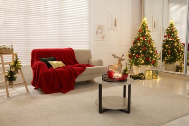 Living room with Christmas decorations. Festive interior design Photo of Living room with Christmas decorations. Festive interior design