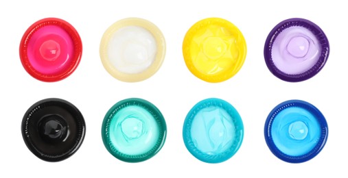 Set with different unpacked condoms on white background, top view Image of Set with different unpacked condoms on white background, top view